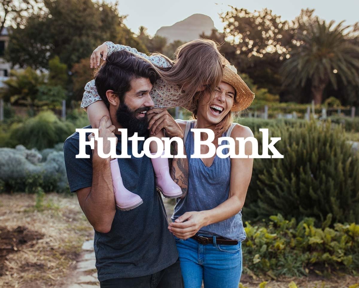 Image of a family hugging with the Fulton Bank logo overlaid