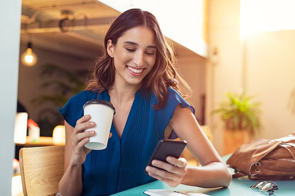 Woman smiling looking at her phone