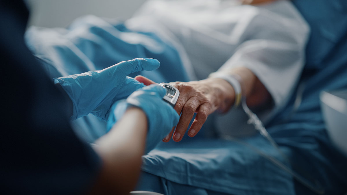 Nurse holding a patients hand
